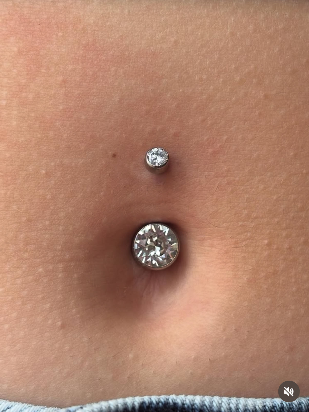 Navel piercing with crystal ball top and silver barbell