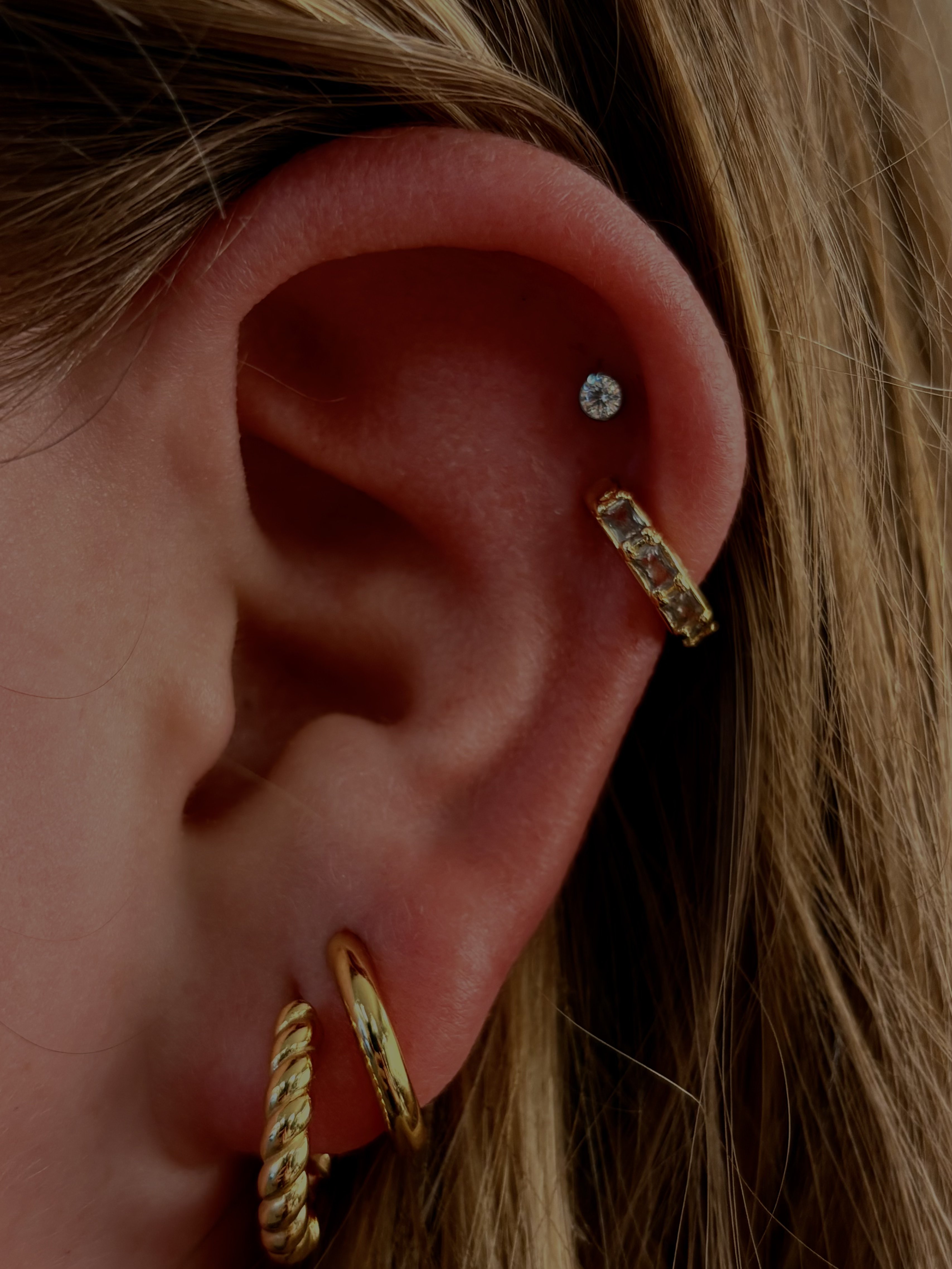 Crystal helix stud with gold ear cuff and gold twisted hoops in lobe