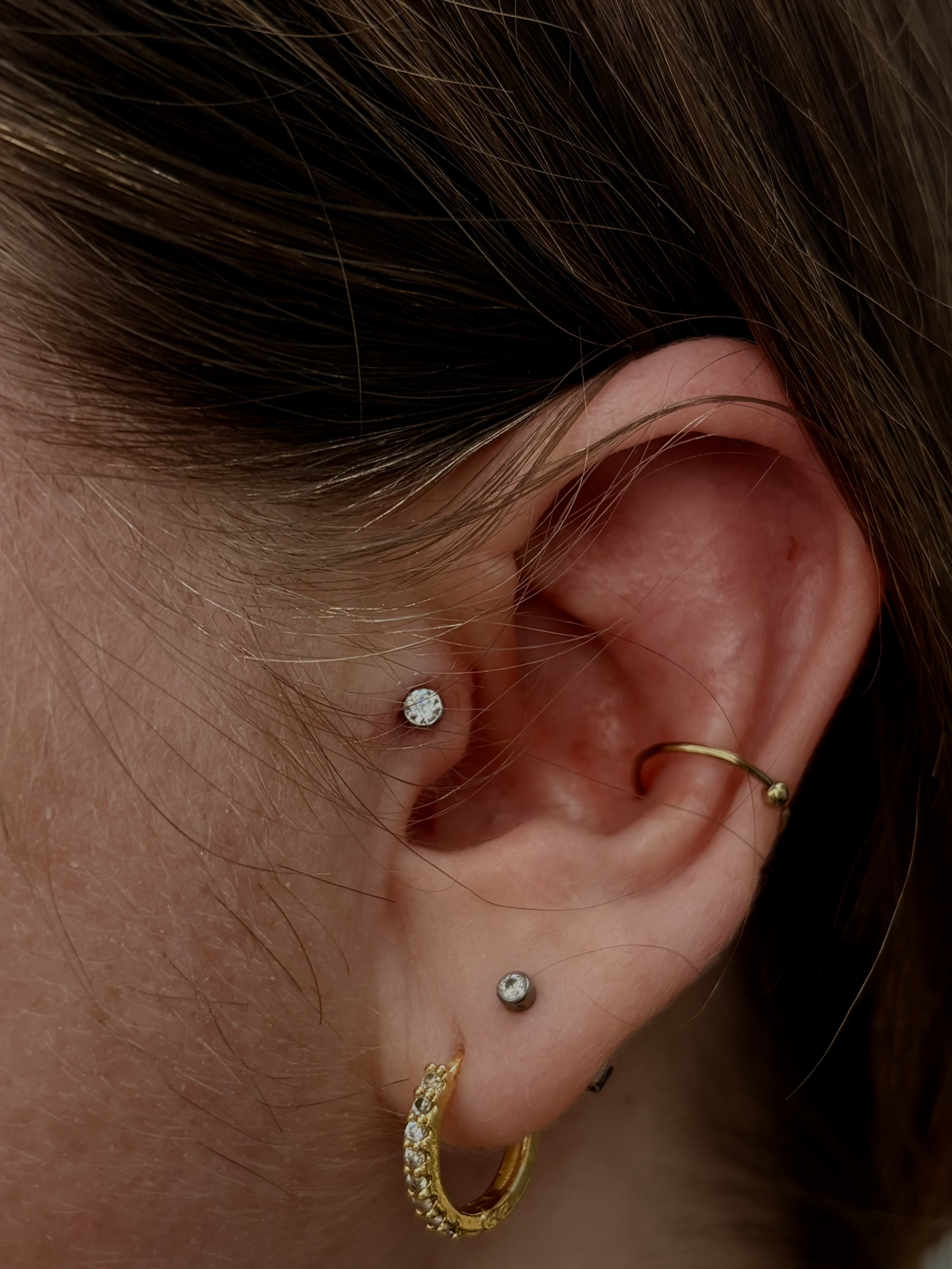 Crystal helix stud with gold conch hoop and crystal ball stud in lobe