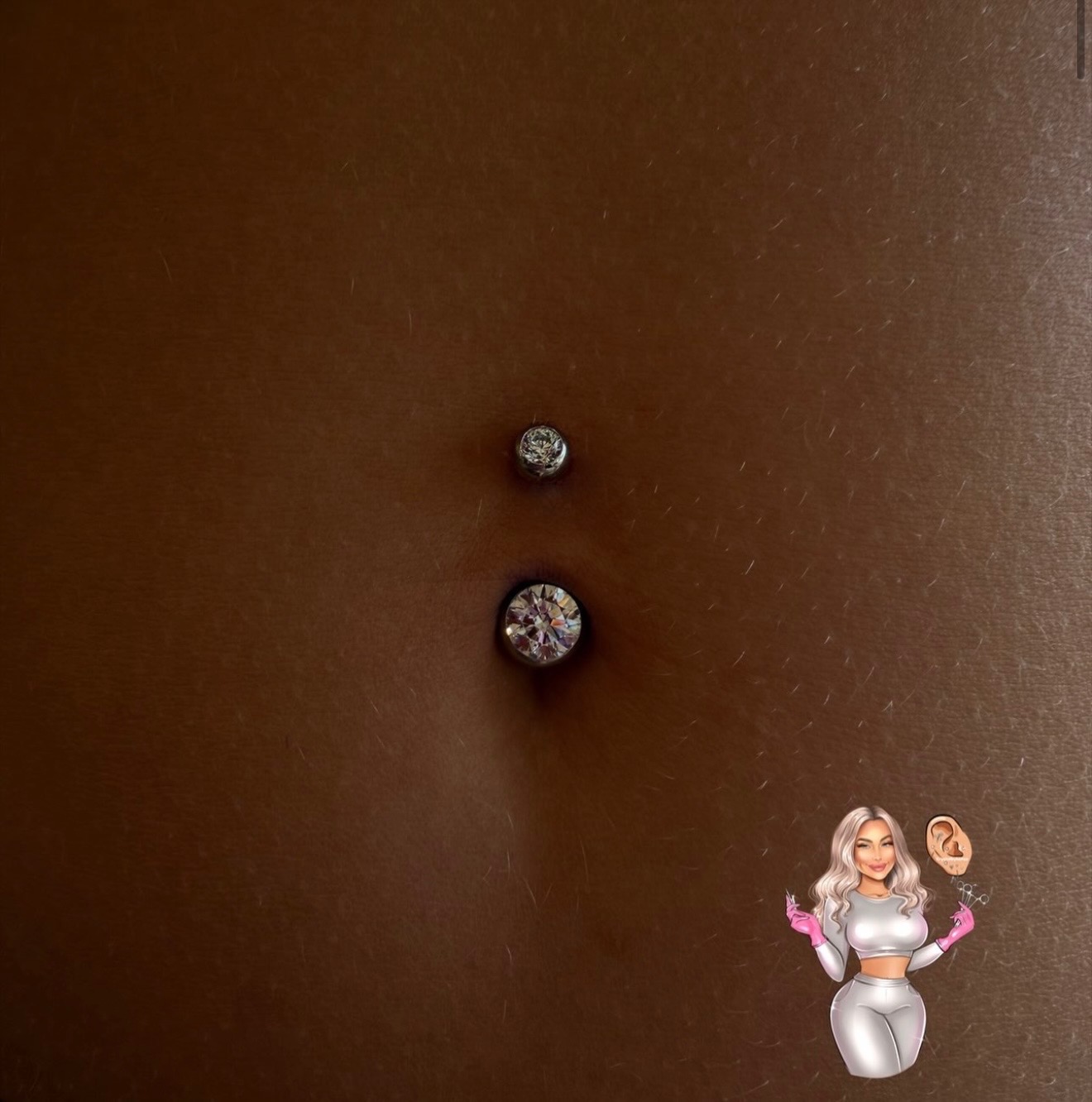 Navel piercing with bezel-set crystals close-up
