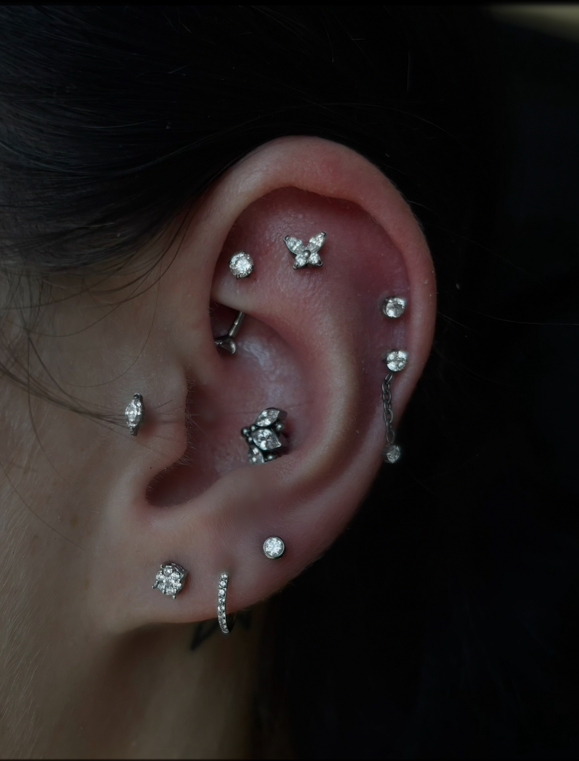 Full curated ear with butterfly crystal helix, marquise conch, crystal chain drop lobe, and crystal huggie hoop