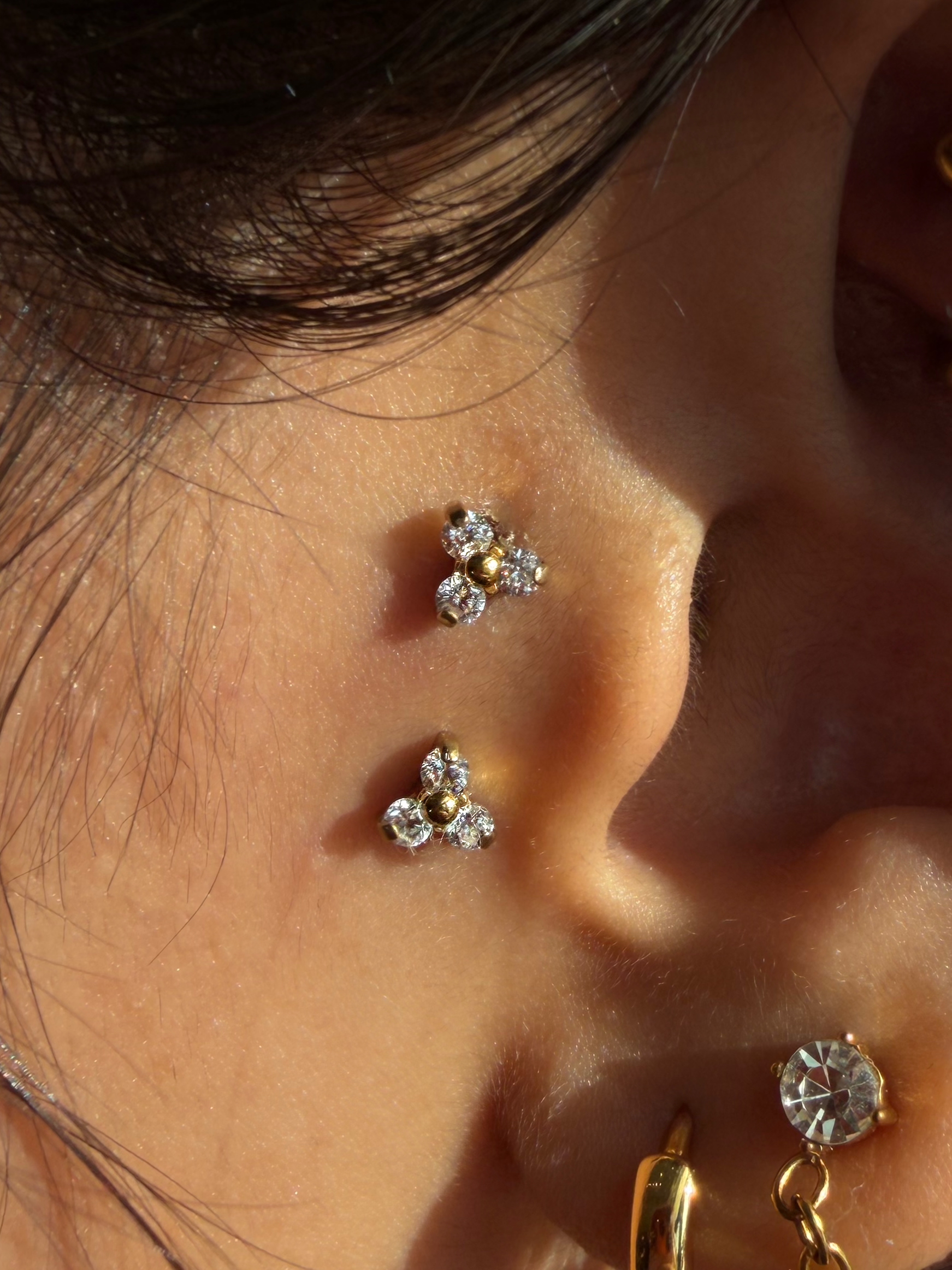 Multiple ear piercings with crystal cluster studs and lobe jewelry
